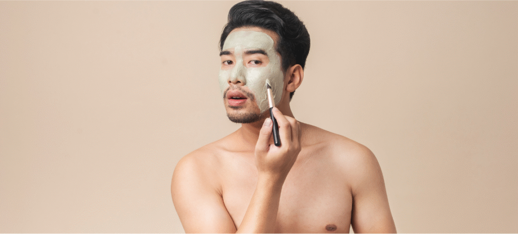Man with stubble beard applying moisturizing face lotion as part of daily skincare routine
