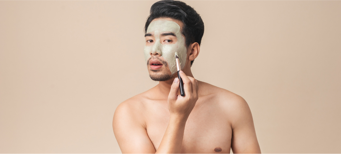 Man with stubble beard applying moisturizing face lotion as part of daily skincare routine