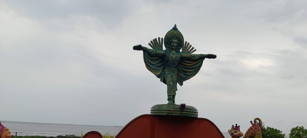 Ancient Udupi Krishna Temple with traditional golden dome and green spire against cloudy sky in Karnataka