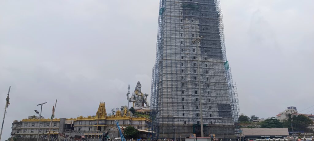Tallest Shiva statue facing the Arabian Sea at Murudeshwar Temple in Karnataka, towering above traditional temple architecture with golden domes