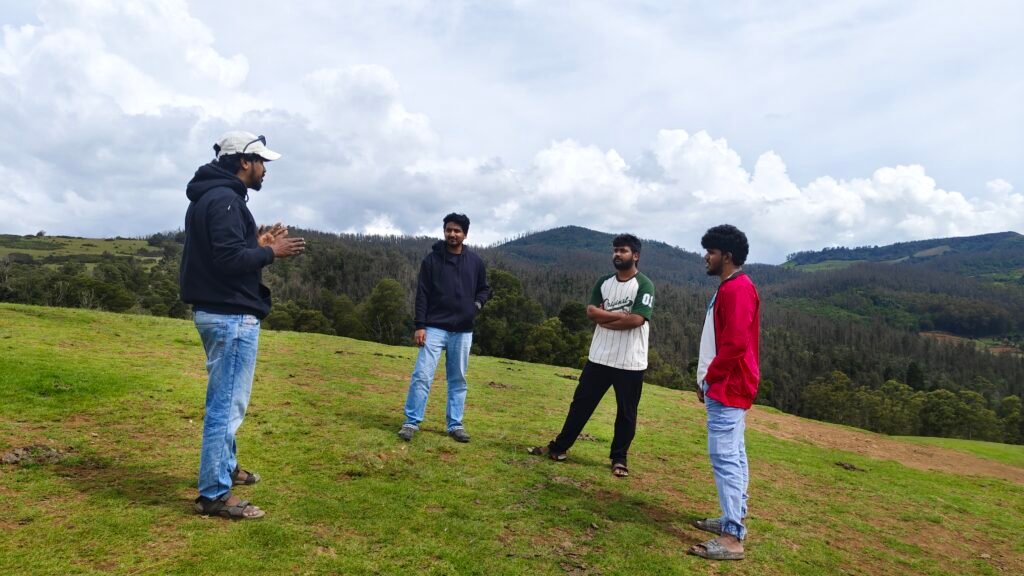 Marketing team shooting ad campaign content on a grassy hilltop in Ooty